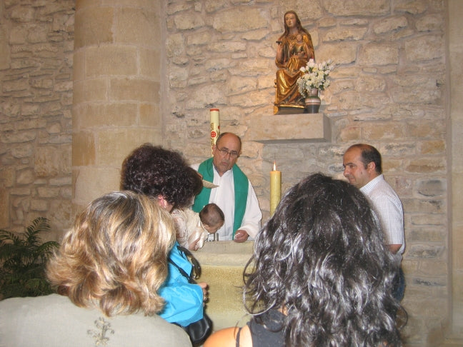 European Catholic baptism ceremony with family and godparents